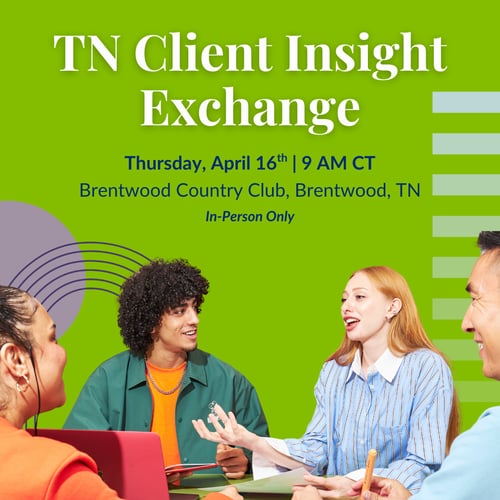 People sitting around a table with laptops and papers, engaging in a discussion under a 