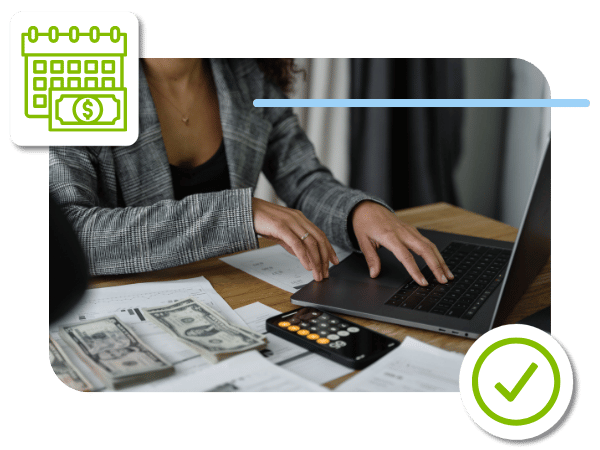 Person working on computer around money and a calculator