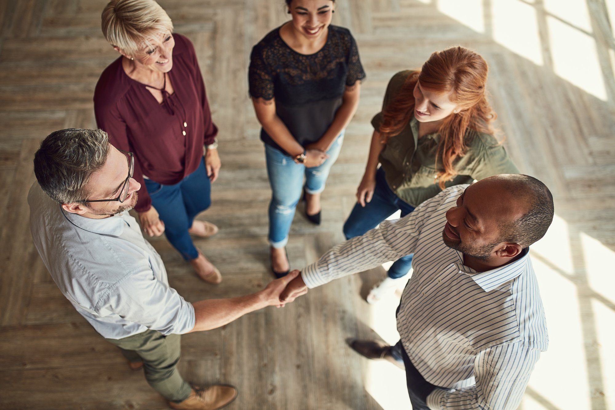 people in a circle shaking hands