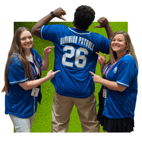 Dominion Payroll team members celebrating partnership success, wearing custom team jerseys in a fun, playful pose