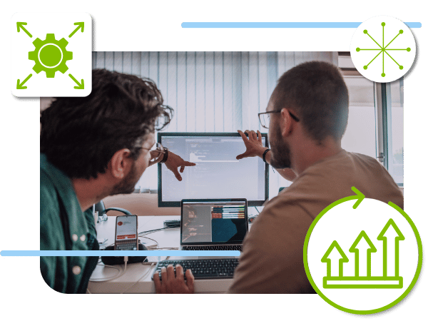 photo of two people pointing to a computer screen with icons overlaying the image of a cog wheel and arrows pointing up